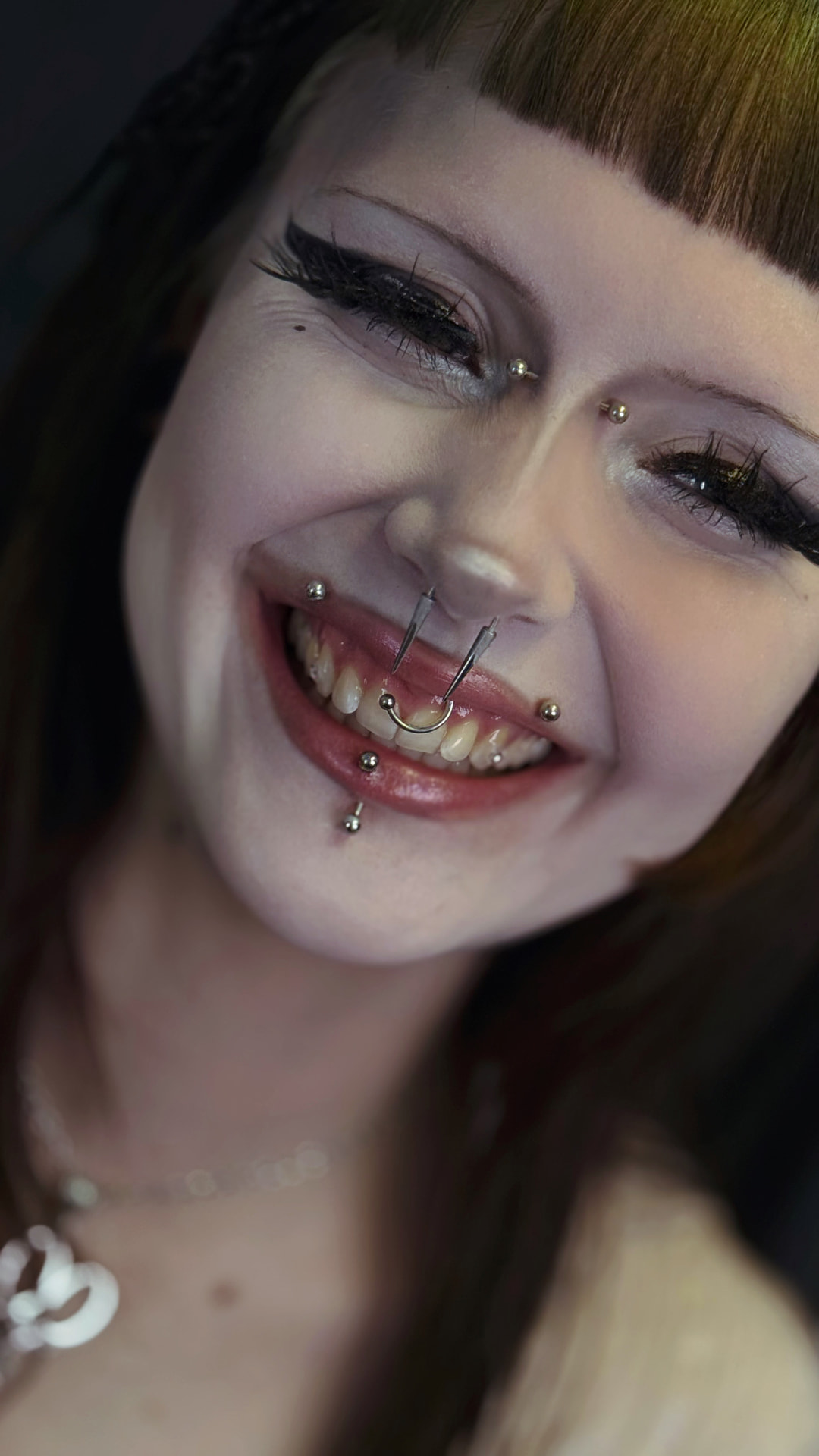 Smile with delicate crystals and silver piercings